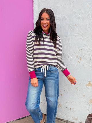 Elevate your wardrobe with this striking striped top featuring bold charcoal stripes accented with vibrant magenta trim. The long sleeves and contrast color detailing create a modern, eye-catching silhouette perfect for layering or wearing solo. The crisp striped pattern pairs effortlessly with neutrals or coordinates with complementary colors for versatile styling options.
house of color Summer
shop by color season
