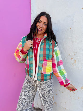 Brighten up your cold-weather wardrobe with the Prism Plaid Jacket. This vibrant multicolor plaid coat combines eye-catching pattern with cozy comfort, making it the perfect layer for fall and winter. The relaxed, comfy fit moves with you through the season while the cheerful design adds personality to any outfit. Layer it over sweaters or wear it solo for effortless style that feels as good as it looks.