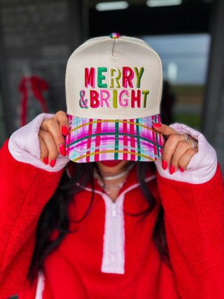Simple message, maximum sparkle. This Confetti Plaid trucker hat features "Merry &amp; Bright" embroidered in colorful, eye-catching thread that matches the playful energy of the print itself. The confetti plaid print brings the festive color palette while the multicolor embroidery ties it all together in the most fun way possible. Easy to wear, easy to love, and easy to pair with literally everything in your holiday rotation. Details Confetti Plaid print "Merry &amp; Bright" embroidered in colorful thread
